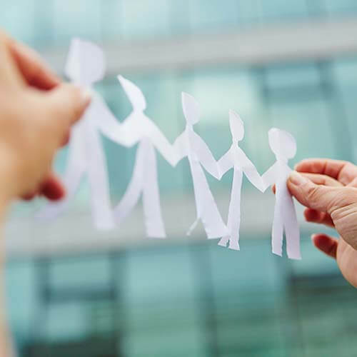 Paper cut outs of business team