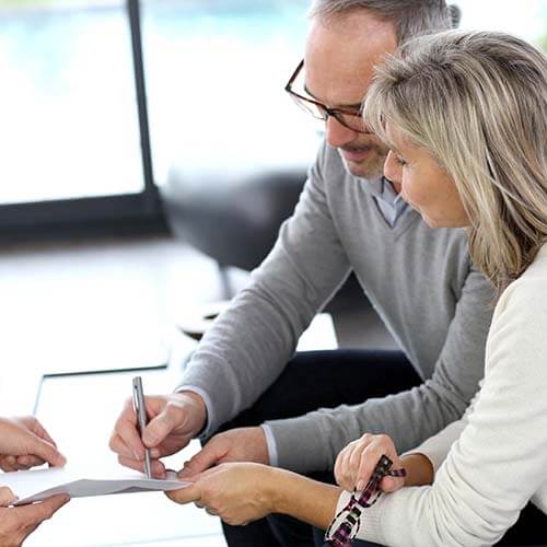 senior couple signing contract