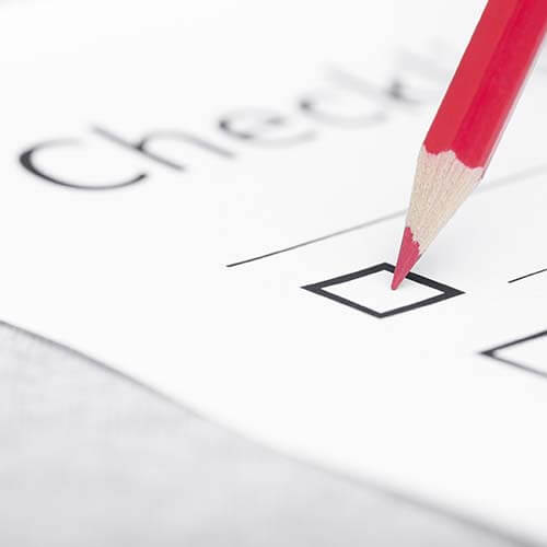 Paper and red pencil signifying checklist of common estate tax audit triggers