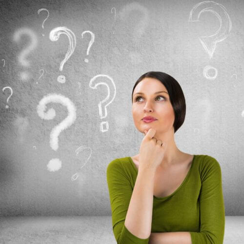 Woman with questioning expression and question marks