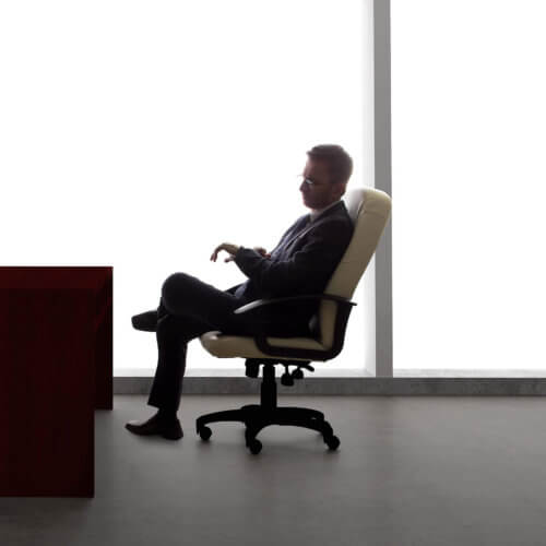 Businessman with an empty chair waiting for a late client