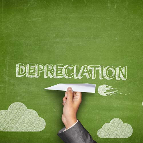 Bonus depreciation concept on blackboard with paper airplane symbolizing new tax law changes