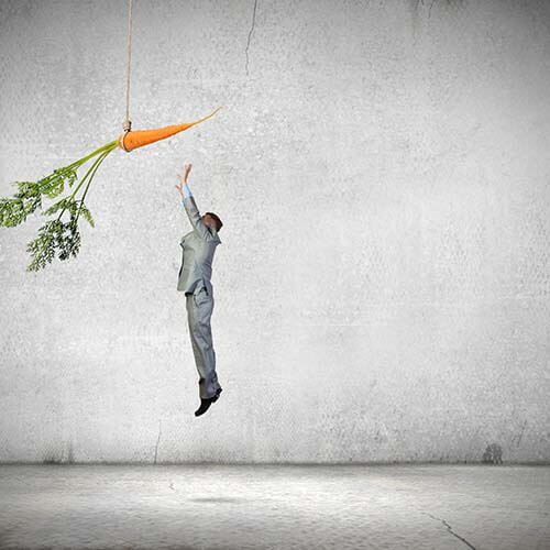 Man jumping for large carrot signifying ESOP SARS or stock appreciation rights