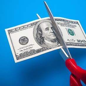 Cutting money with scissors