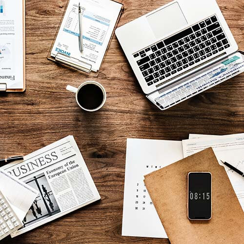 laptop with coffee and paperwork