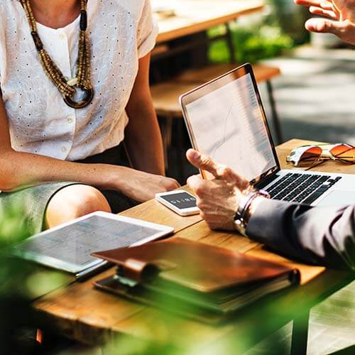 Business team working with laptop outside