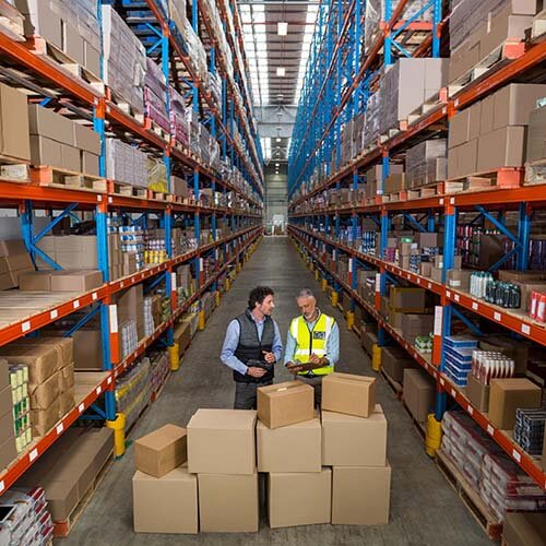 two workers in warehouse with inventory