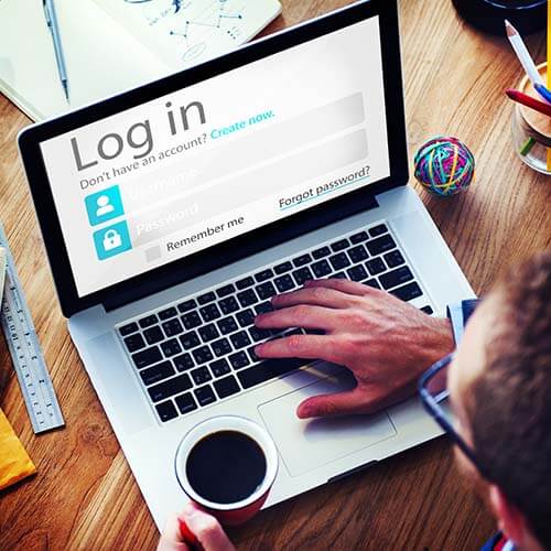 Man with laptop looking at login screen