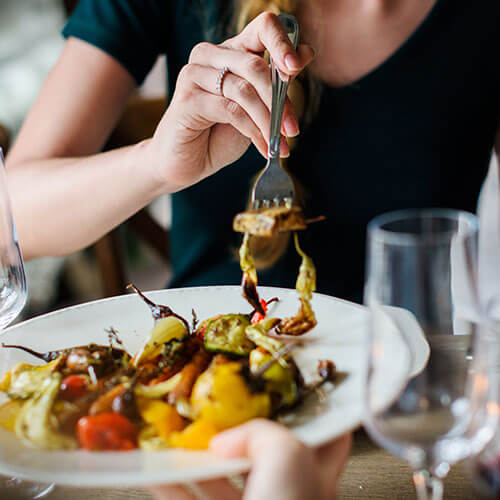 woman eating plate of food