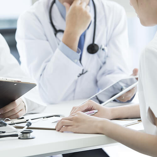 doctor and nurse looking at chart