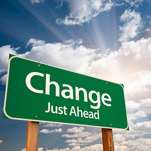 Green change sign with sky in background