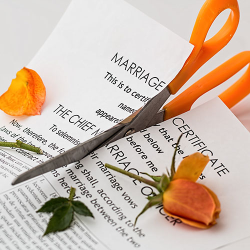 scissors cutting marriage certificate