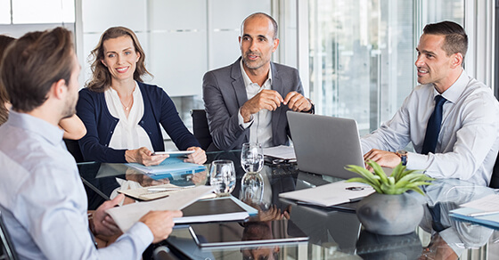 Multiethnic group of business people sitting in annual meeting in conference room.