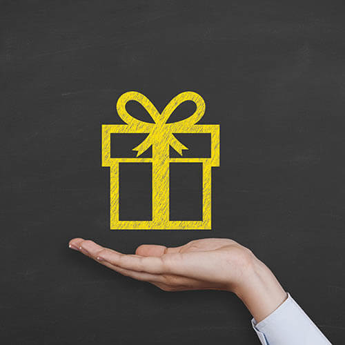 woman's hand holding image of gold gift box