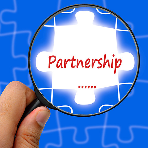Partnership word. Magnifier and puzzles.