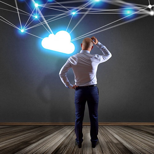 Businessman in front of a wall with a Cloud network with net and connection - Technology concept