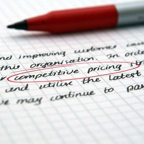 Image of red pen on white paper with competitive pricing circled