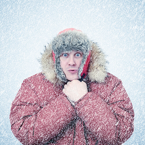 Man in winter coat with falling snow