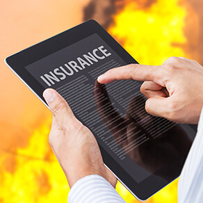 man holding iPad and filing a business interruption claim