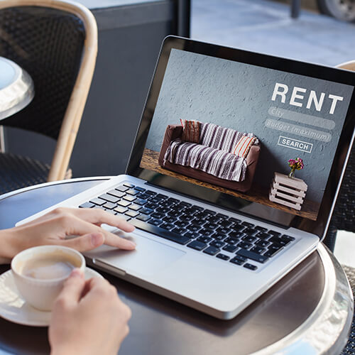 woman looking on laptop for rental properties
