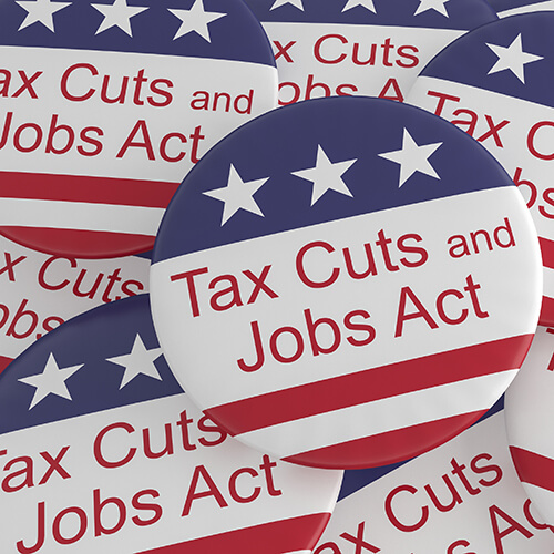 red white and blue button with Tax Cuts and Jobs Act words