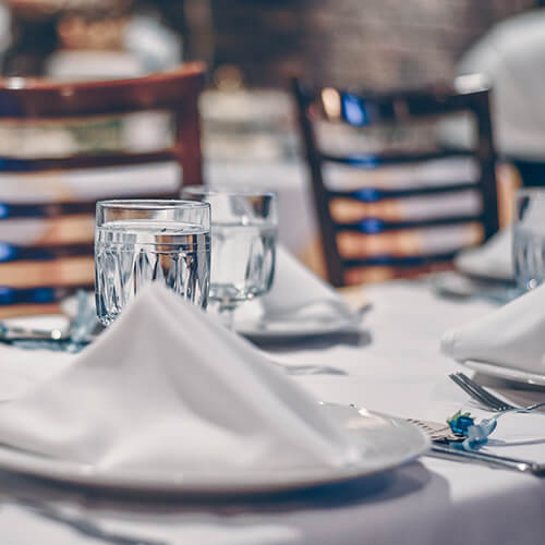table set with white linens