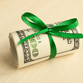 money wrapped with green ribbon