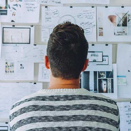 man looking at board with strategic goals