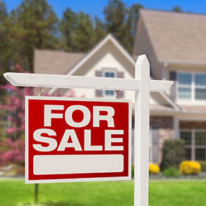 for sale sign in front yard
