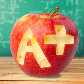 apple with carved A and plus sign