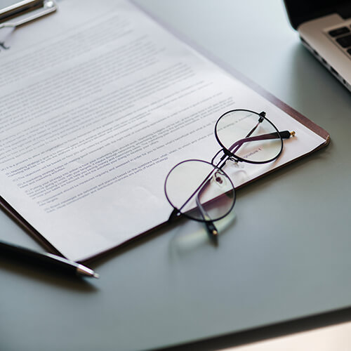 document with pen and eyeglasses