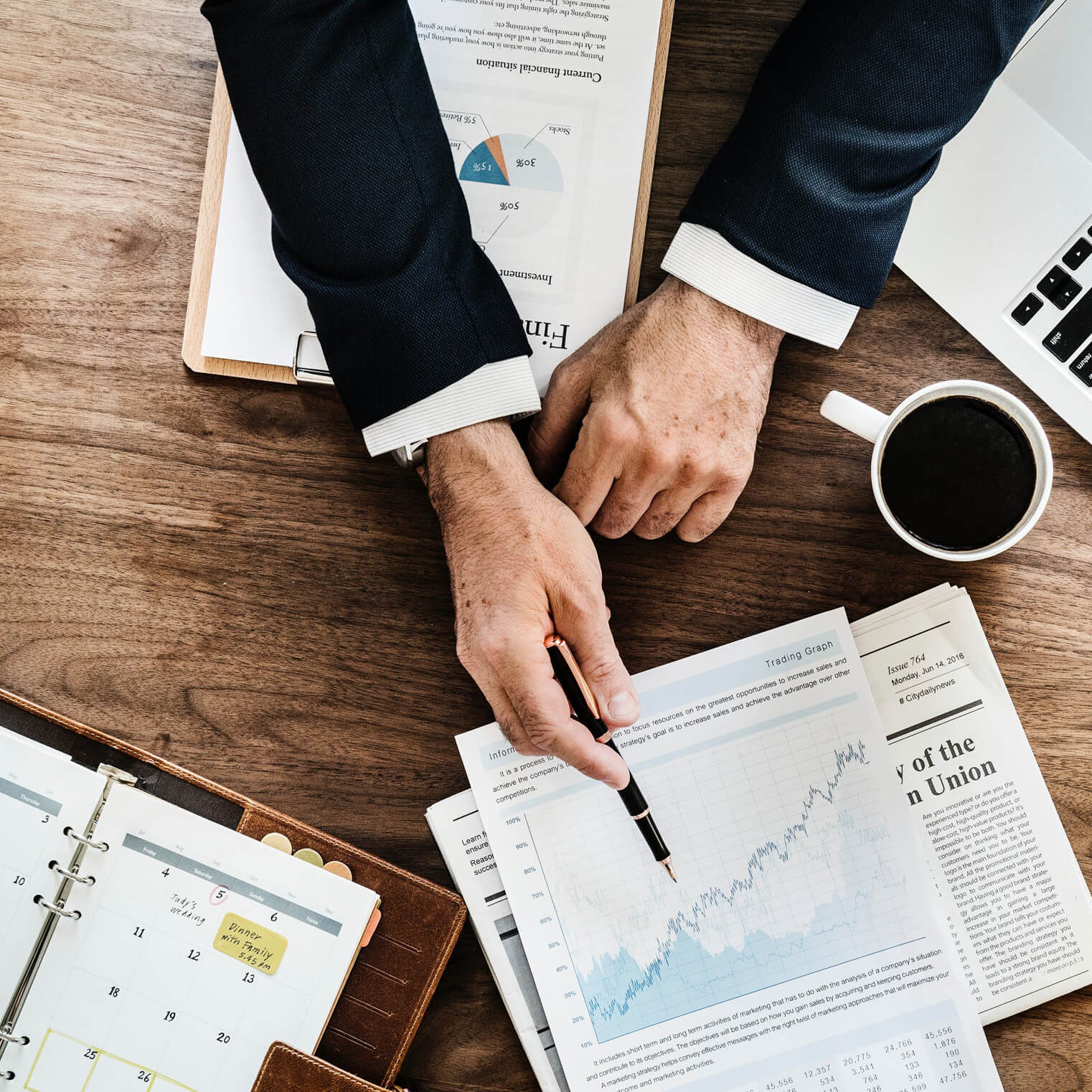 man with pen and stock chart