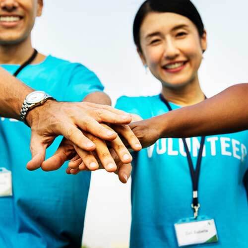 volunteers hands together