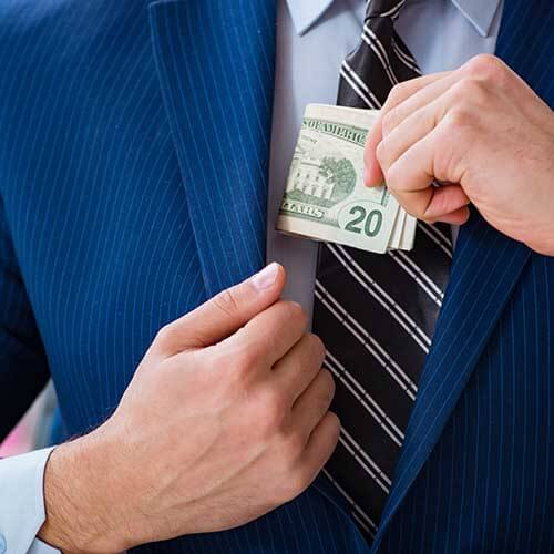 Man putting money in suit pocket