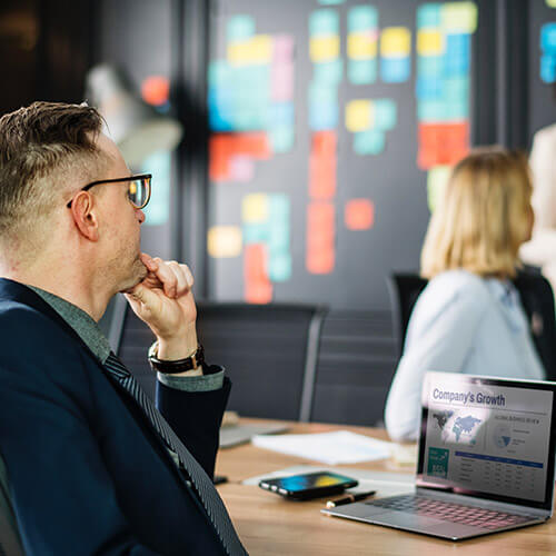 man in back of room during presentation