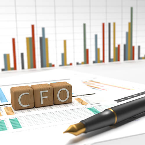 Chief Financial Officer - CFO - 3 wooden dice containing the letters CFO with charts on the background.