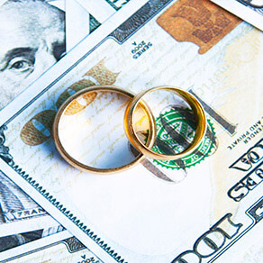 two wedding rings on top of money