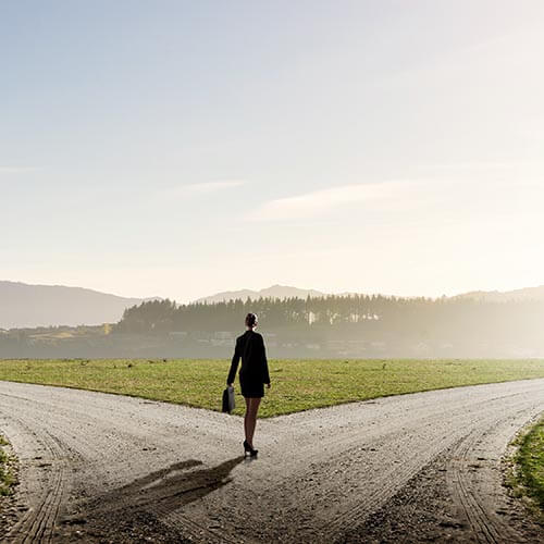 woman walking on path with two options