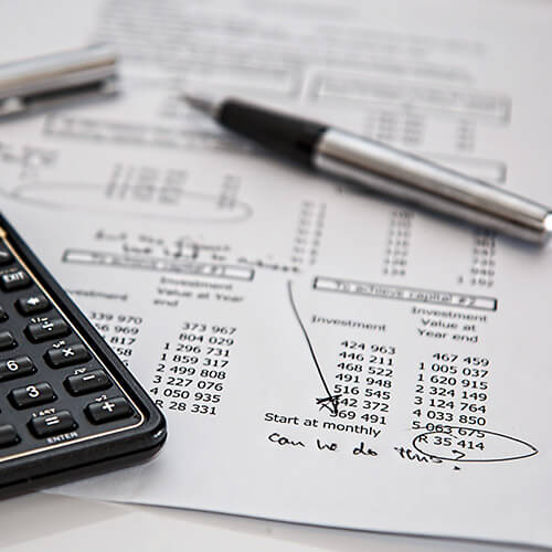 financial statement with calculator and pen for nonprofit investments