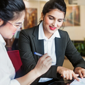 two women looking at financial